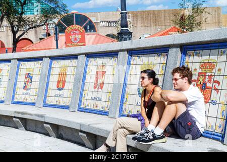 New Orleans Louisiana,Spanish Plaza,public park,square,bench,tiles,seals,coat of arms,man men male,woman female women,couple,resting,relaxing,sitting, Stock Photo