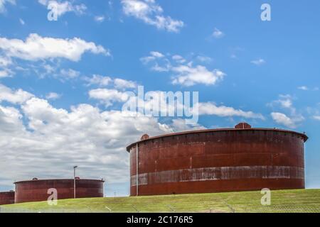 Huge rusty storage tanks full of petroleum products in tank farm in Cushing Oklahoma where most oil in USA is stored and traded Stock Photo