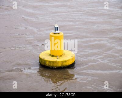 Yellow buoy floating on water Stock Photo