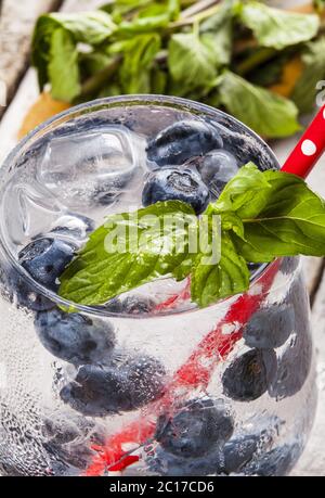 Summer cold drink with blueberry, mint and ice on white wooden background Stock Photo