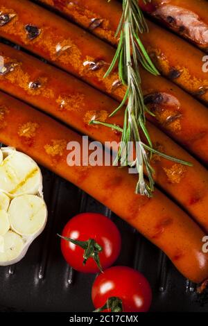Closeup of Wiener Sausages in a pan Stock Photo