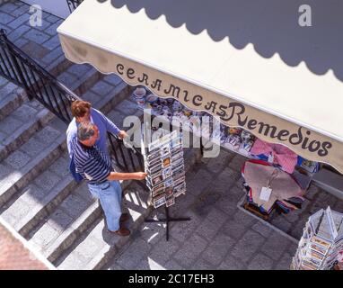 Couple looking at postcards in souvenir shop, Mijas, Costa del Sol, Malaga Province, Andalusia (Andalucia), Spain Stock Photo