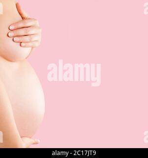 Pregnant woman big 9 month baby bump under white cloth Stock Photo - Alamy