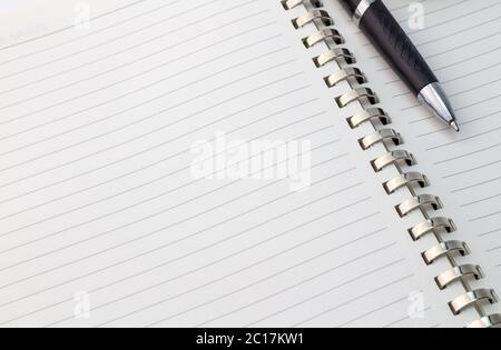 Close up view of note book with silver metal binder and pen with space for text - business backgroun Stock Photo