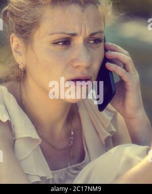 Girl talking on phone and being shocked Stock Photo