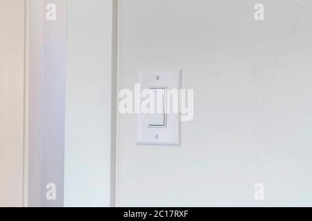 Indoor electrical light switch of home mounted on white wall background Stock Photo