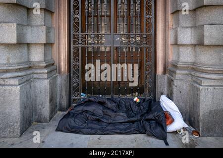 A rough sleeper’s bedding and personal belongings seen during the day in Whitehall, London, UK Stock Photo