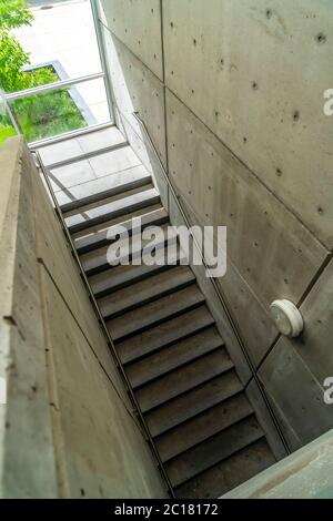 Looking down on staircase with metal handrails inside of commercial building Stock Photo