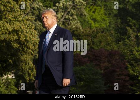 Washington, United States. 14th June, 2020. U.S. President Donald Trump walks on the South Lawn of the White House after arriving on Marine One in Washington, DC on Sunday, June 14, 2020. Trump tweeted that he will not watch the NFL or the U.S. Soccer Federation if either organization allows players to kneel during the playing of the national anthem. Photo by Stefani Reynolds/UPI Credit: UPI/Alamy Live News Stock Photo