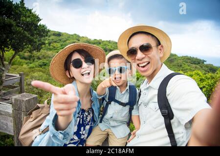 happy asian Family On Hiking Adventure and taking selfie Stock Photo