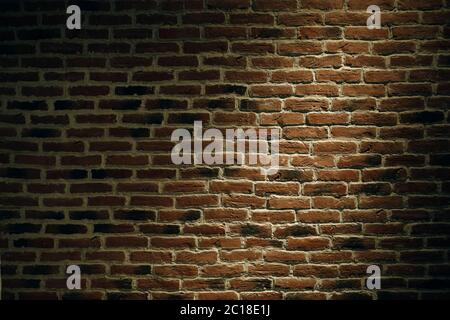 The texture of a brick wall with a light spot. Stock Photo