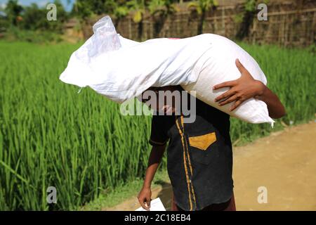 Rohingya children collect food aid at Palangkhali refugee camp in Cox's