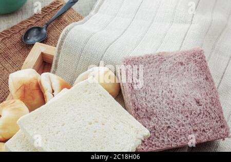 breads and cups on tablecloth. Stock Photo