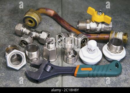 adjust wrench power grip and elements of water and gas shutoff valves Stock Photo