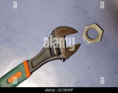 adjust wrench power grip and nut, flat lay Stock Photo