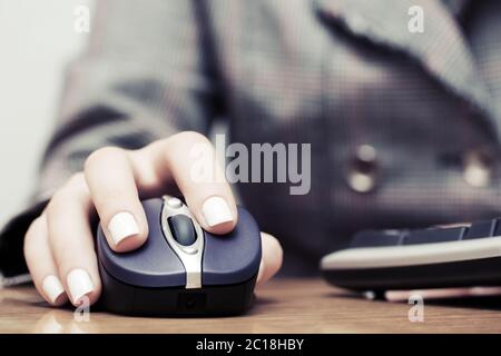 Woman using computer mouse and keyboard Stock Photo