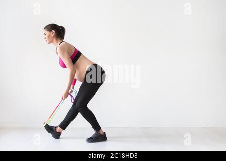 One young pregnant woman doing fitness exercises Stock Photo