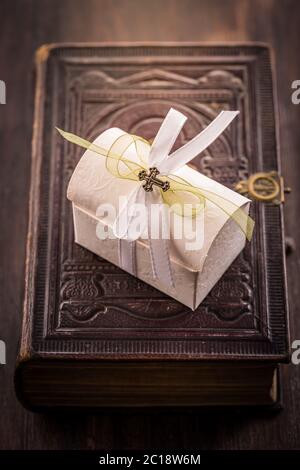 First holy communion - present box on old bible in vintage style Stock Photo