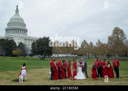 Latino wedding couple and their family happily taking photographs in front of United States Capitol building Stock Photo