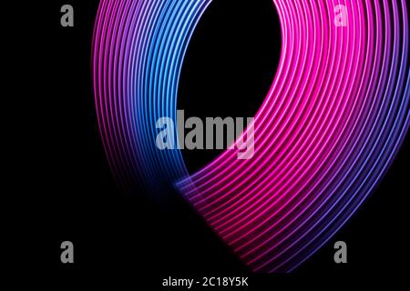 Abstract light blue, pink and purple trails in random motion background image. Striped Neon Lights in Rainbow Colors Stock Photo