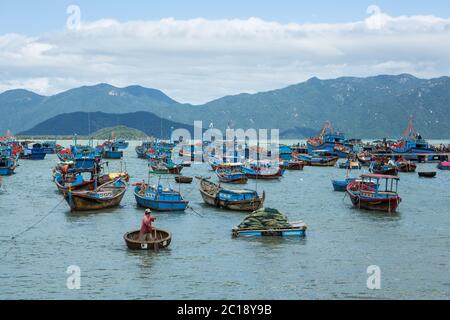 Traditional old wooden Vietnamese boats and round fishing boats Thung Chai. Local woven bamboo basket boats or coracle moored ne Stock Photo
