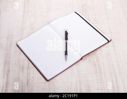 top view of open book with pen on wooden table Stock Photo