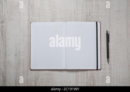 Blank notepad with pen and pencil on office wooden table Stock Photo