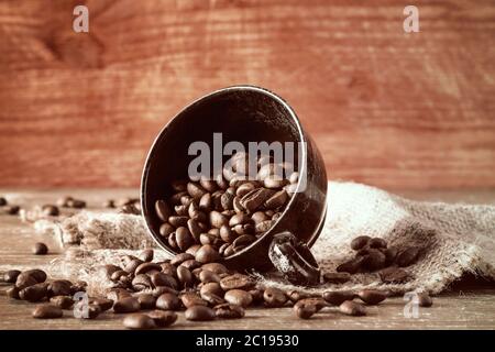 Coffee beans spilled out of a cup Stock Photo