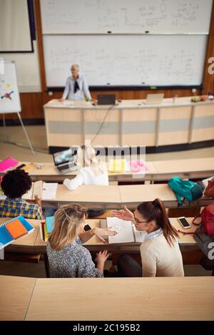 Students discussing while having lecture in amphitheater Stock Photo