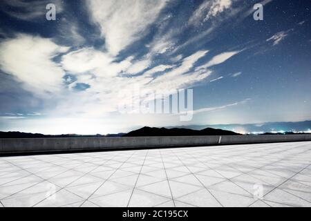 empty marble floor with green hill in star sky Stock Photo