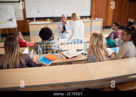 Professor explaining the lecture to the students in amphitheater Stock Photo