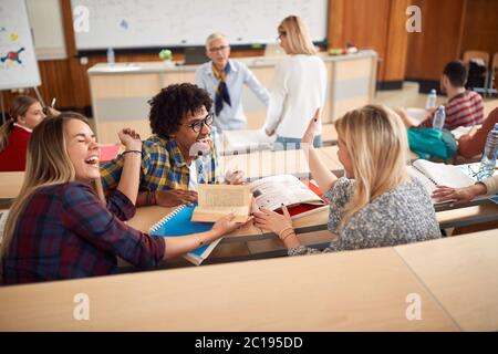 Students laughing while having lecture in amphitheater Stock Photo