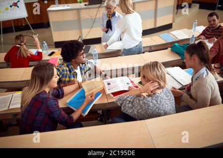 Students discussing while having lecture in amphitheater Stock Photo