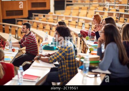 Young students focused on lecture in amphitheater Stock Photo
