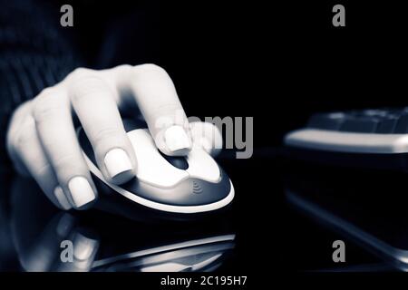 Female hand using computer mouse Stock Photo