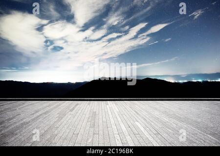 empty brick floor with green hills Stock Photo