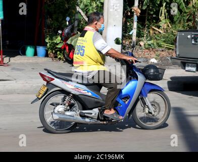 SAMUT PRAKAN, THAILAND, JUN 03 2020, A traditional taxi on motorbike. Mototaxi driver rides on a motorcycle on street city. Stock Photo