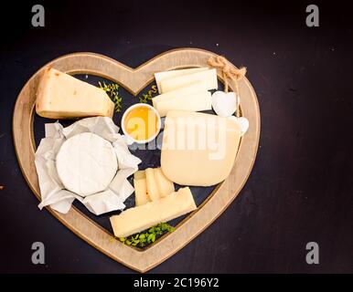 various types of cheese on rustic wooden table Stock Photo