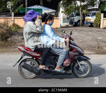 AYUTTHAYA, THAILAND, JUN 03 2020, A pair of women rides a motorcycle on the road. Stock Photo