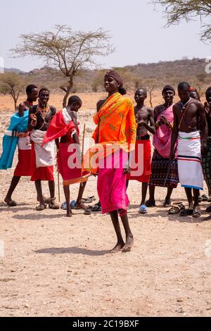 Maasai men wearing traditional attire, members of the Samburu tribe, in a traditional dance, in Samburu National Reserve. Kenya. Africa. Stock Photo