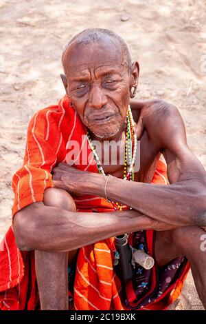 Close up portrait of a maasai old man, wearing traditional attire, member of the Samburu tribe, in a Samburu village. Samburu National Reserve. Kenya.