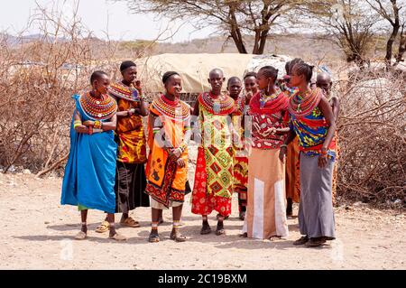 Maasai women wearing traditional attire, members of the Samburu tribe, in a Samburu village, in Samburu National Reserve. Kenya. Africa. Stock Photo