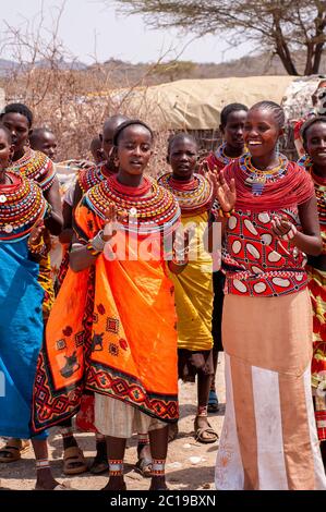 Maasai women wearing traditional attire, members of the Samburu tribe, in a traditional dance, in Samburu National Reserve. Kenya. Africa. Stock Photo