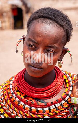 Close up protrait of a woman, wearing traditional attire, member of the Samburu tribe, in a Samburu village. Samburu National Reserve. Kenya. Africa.