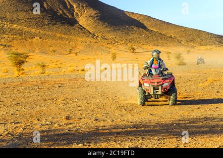 Ait Saoun, Morocco - February 23, 2016: Woman riding quad bike in the desert Stock Photo