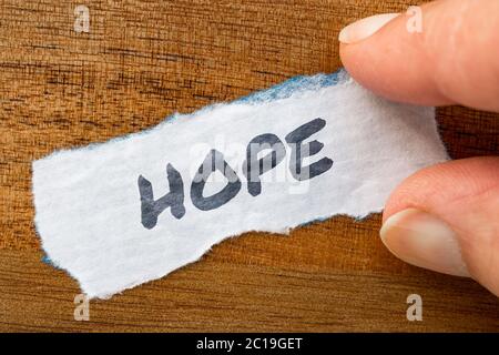 Hope concept and theme written on old paper on a grunge background Stock Photo