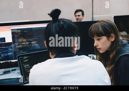 Two Online Data Security Workers Discussing work Stock Photo