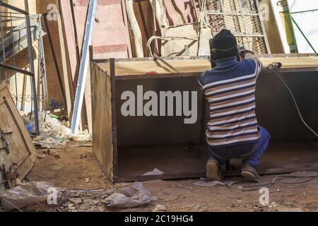 Rear view of welder using welding machine Stock Photo