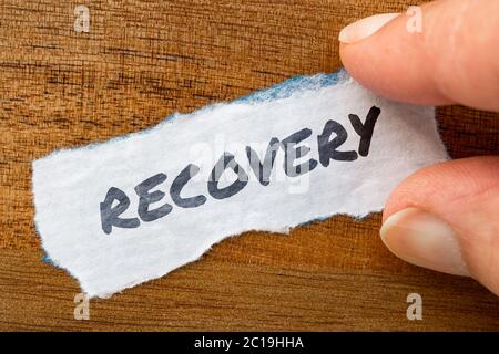 Recovery concept and theme written on old paper on a grunge background Stock Photo