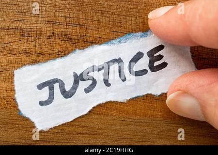 Justice concept and theme written on old paper on a grunge background Stock Photo